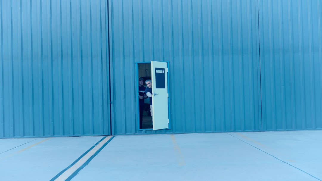 a-person-peeking-through-an-open-door-ccpzd5m6obk